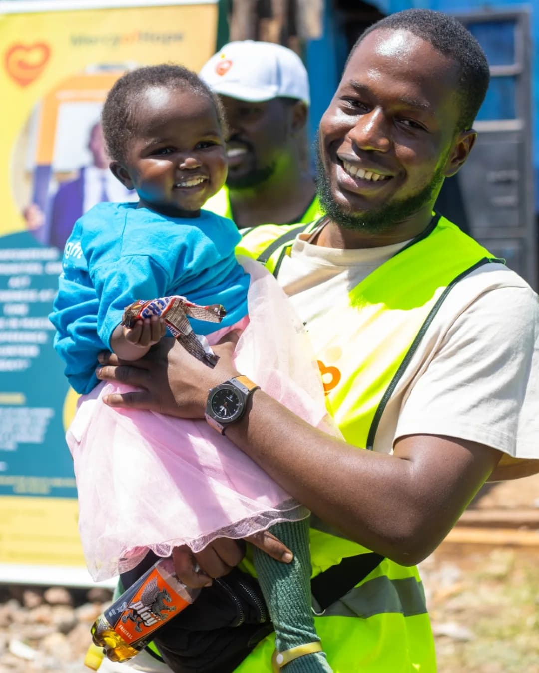 A community health volunteer holding a newborn